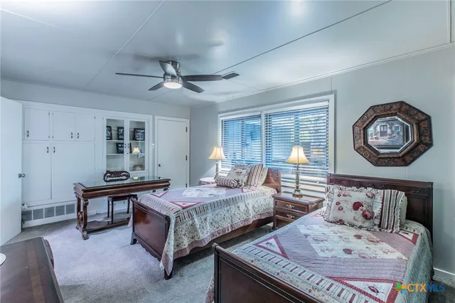 a bedroom with two beds and a large mirror