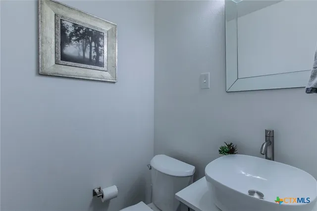a white toilet sitting next to a white walls