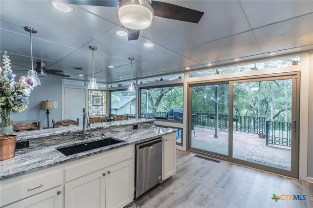 a kitchen with a sink and a large window