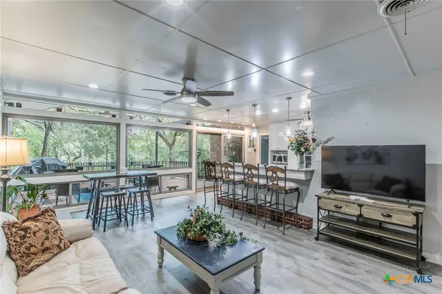 a living room with lots of furniture and a flat screen tv