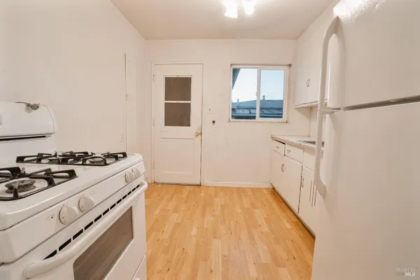a kitchen with a stove and a white cabinet