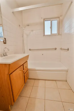 a bathroom with a bathtub sink and vanity