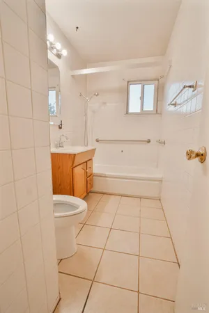 a bathroom with a sink a toilet and mirror