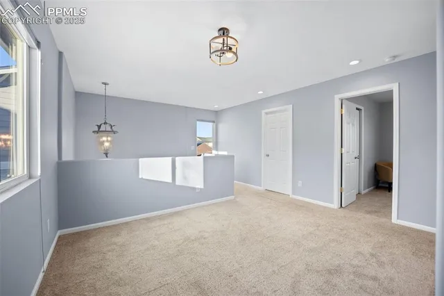 a view of a kitchen with wooden cabinet and a ceiling fan