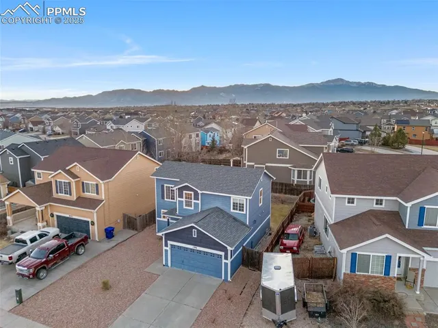 an aerial view of houses with a city