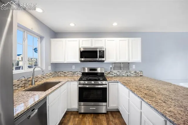 a kitchen with a stove a sink and a microwave