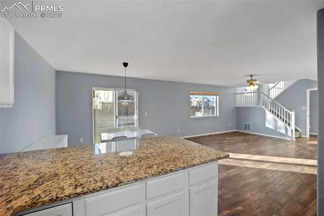 a view of a kitchen with granite countertop