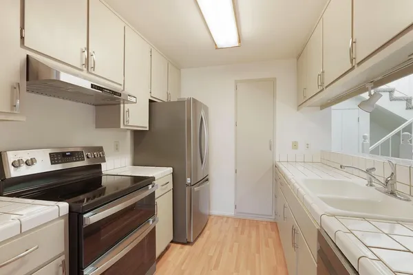 a kitchen with a sink appliances and cabinets
