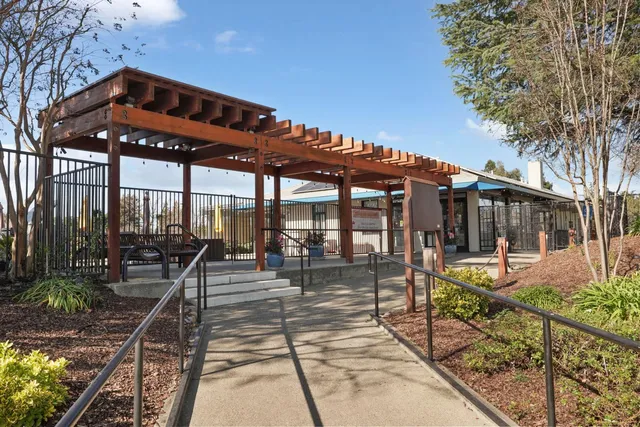 a view of a chairs and tables in the patio with a small pool