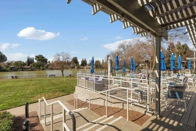a view of a lake with a table and chairs