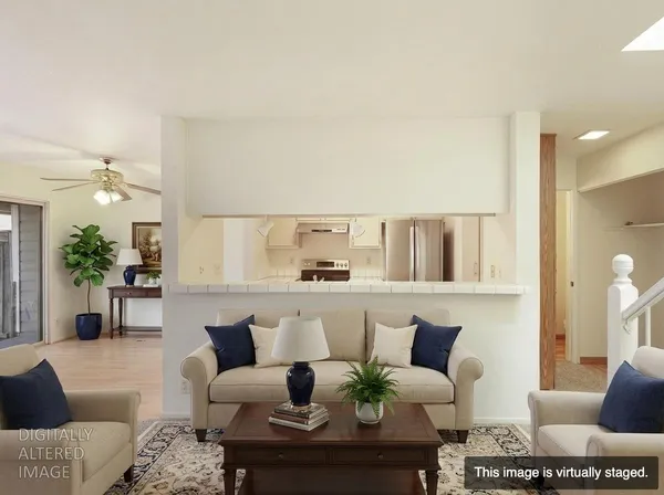 a living room with furniture and a large mirror