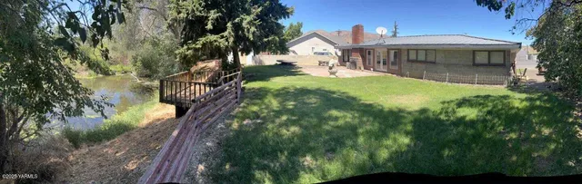 a view of a house with backyard and porch