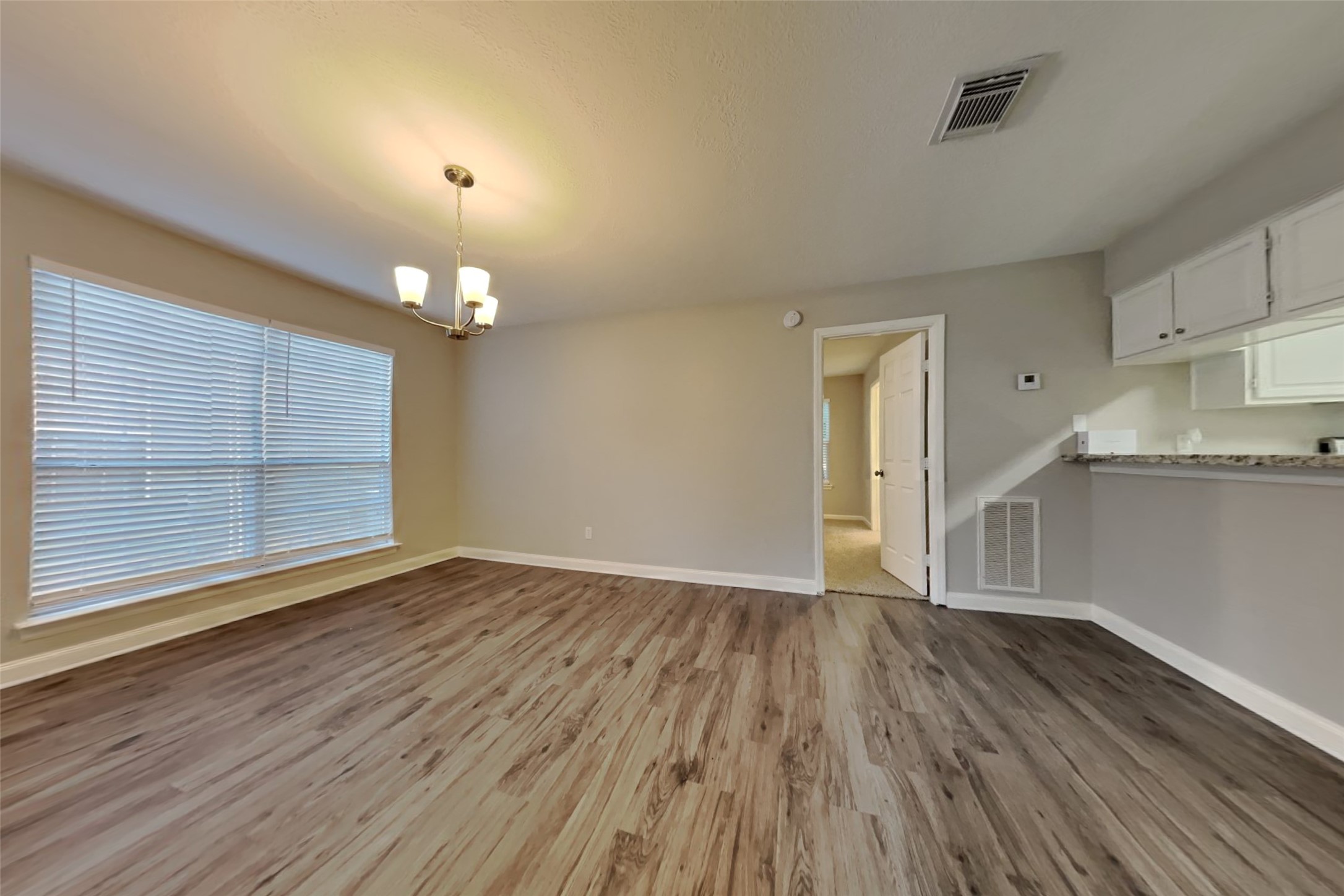 3602 Appalachian Trail Houston, TX 77345 - Photo 9 of 21 an empty room with wooden floor and windows