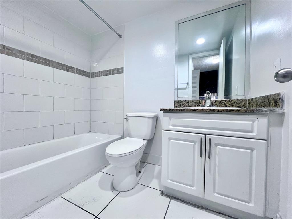 2580 Northwest 56th Avenue, Unit 700420 Lauderhill, FL 33313 - Photo 8 of 16 a bathroom with a sink a toilet and a bathtub