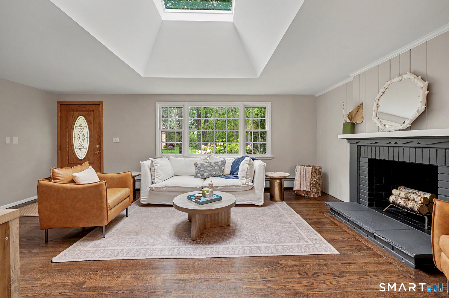 19 Geneva Road Norwalk, CT 06850 - Photo 7 of 33 a living room with furniture a fireplace and a large window