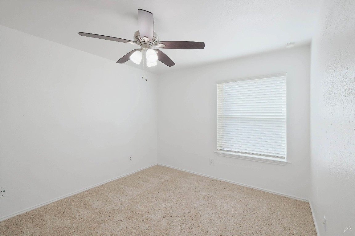 2323 Wells Branch Parkway, Unit C102 Austin, TX 78728 - Photo 9 of 20 Carpeted empty room featuring a ceiling fan and baseboards