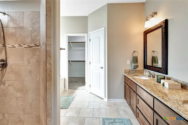 a bathroom with a granite countertop sink mirror and a