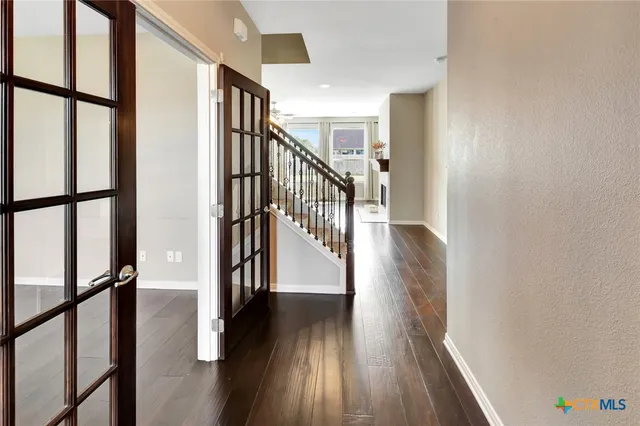 a view of staircase with wooden floor and a window