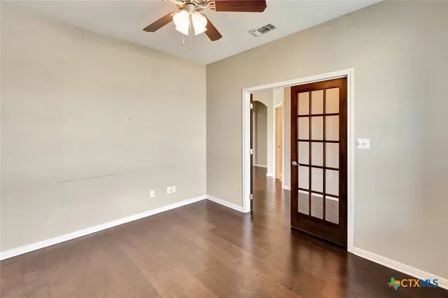 wooden floor in an empty room with a window