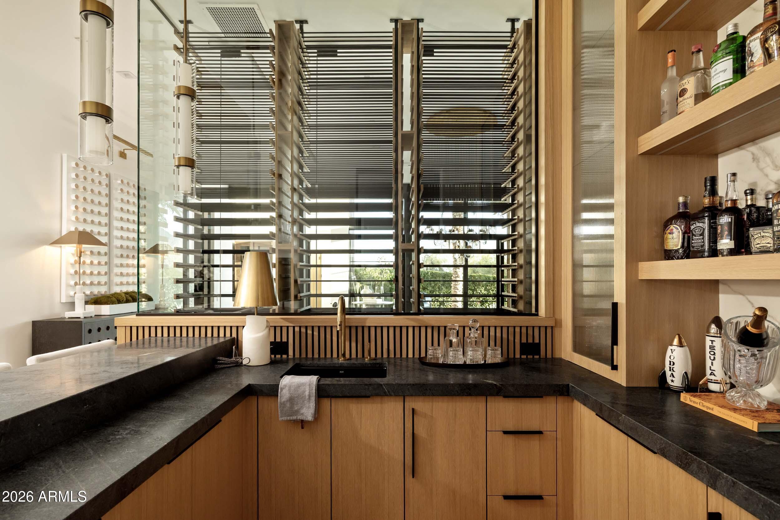 6800 North Mummy Mountain Road Paradise Valley, AZ 85253 - Photo 11 of 61 a kitchen with granite countertop a sink and a window
