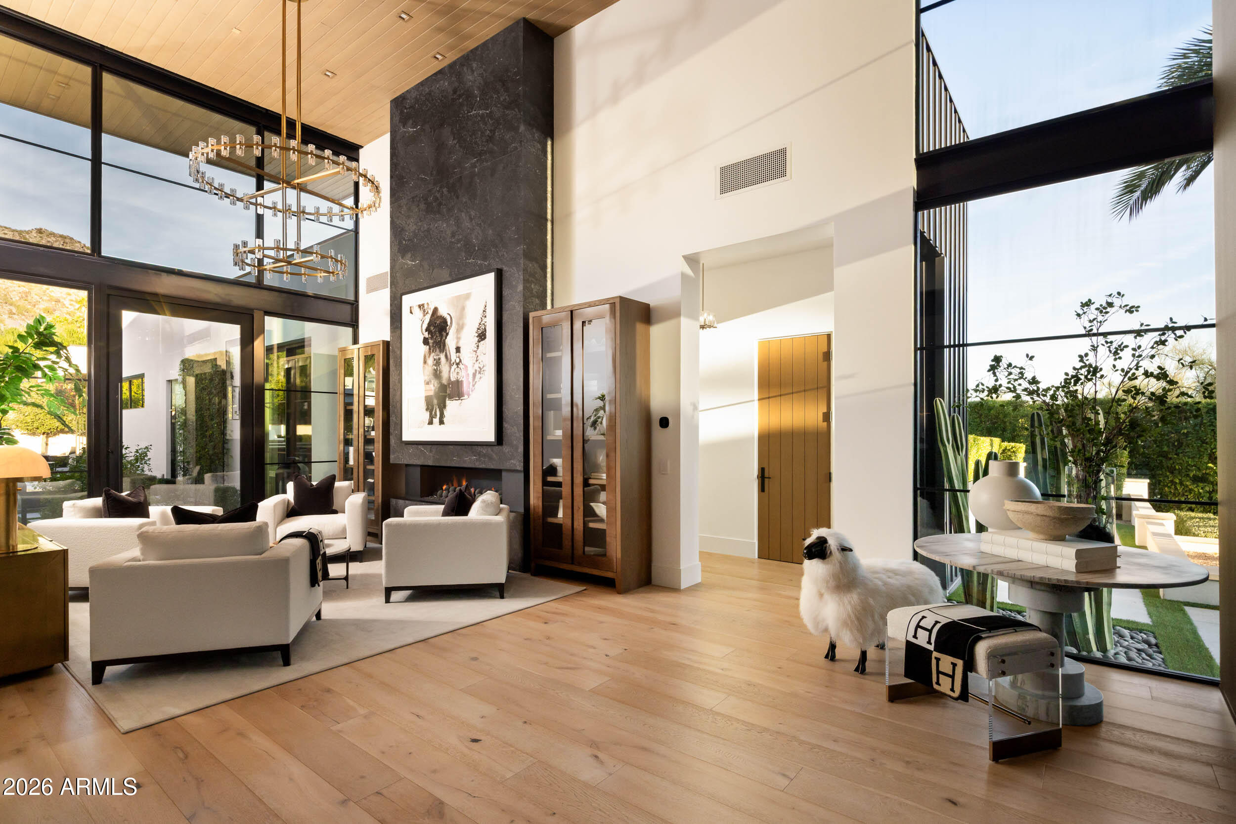 6800 North Mummy Mountain Road Paradise Valley, AZ 85253 - Photo 16 of 61 a living room with furniture a large window and wooden floor