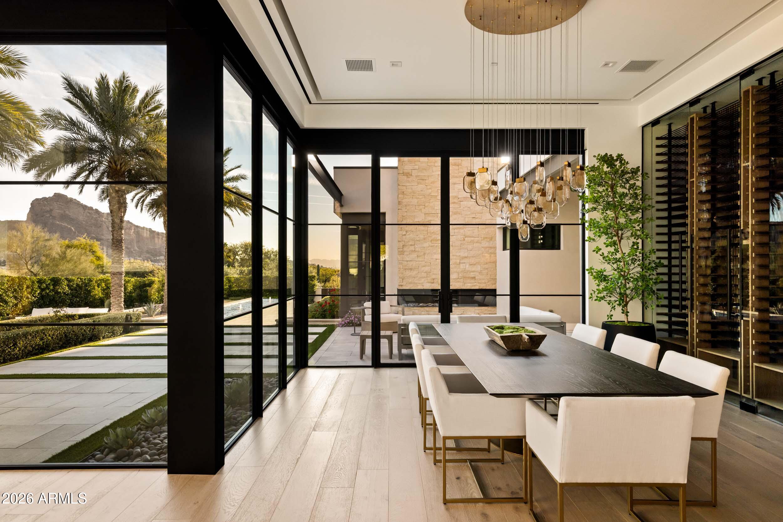 6800 North Mummy Mountain Road Paradise Valley, AZ 85253 - Photo 18 of 61 a dining room with furniture and wooden floor