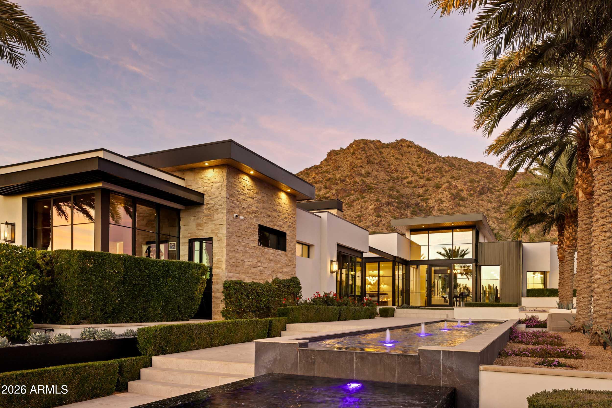 6800 North Mummy Mountain Road Paradise Valley, AZ 85253 - Photo 2 of 61 a front view of a house with a yard