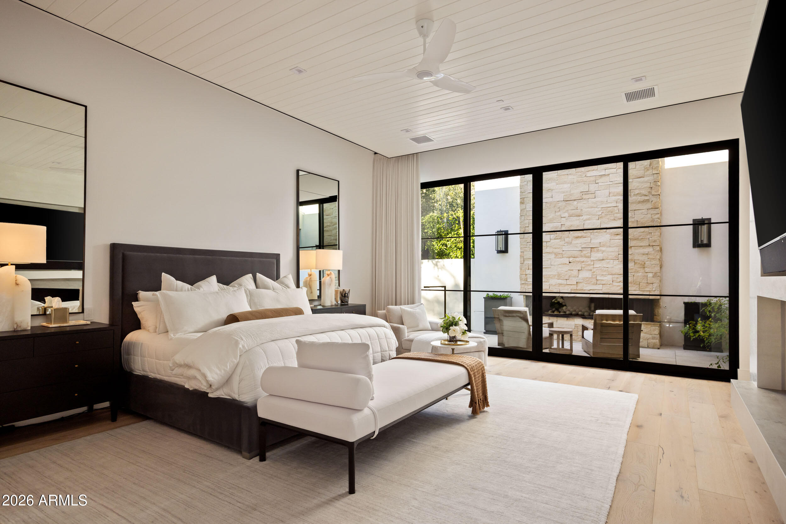 6800 North Mummy Mountain Road Paradise Valley, AZ 85253 - Photo 22 of 61 a bedroom with a large bed and a large window