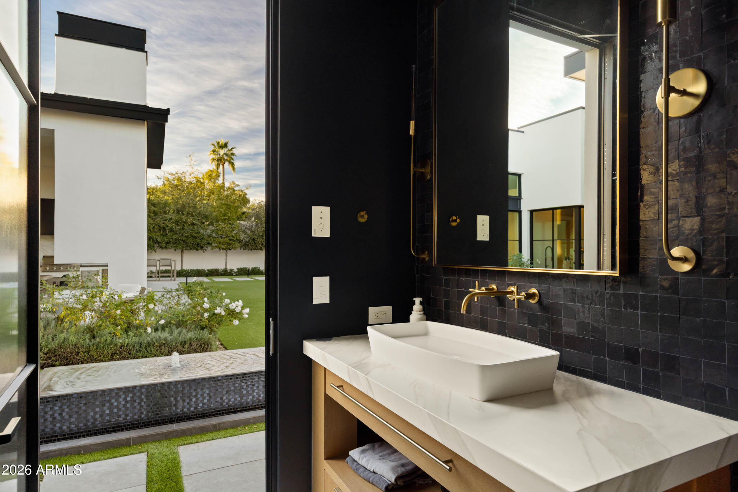 6800 North Mummy Mountain Road Paradise Valley, AZ 85253 - Photo 29 of 61 a bathroom with a sink and a mirror