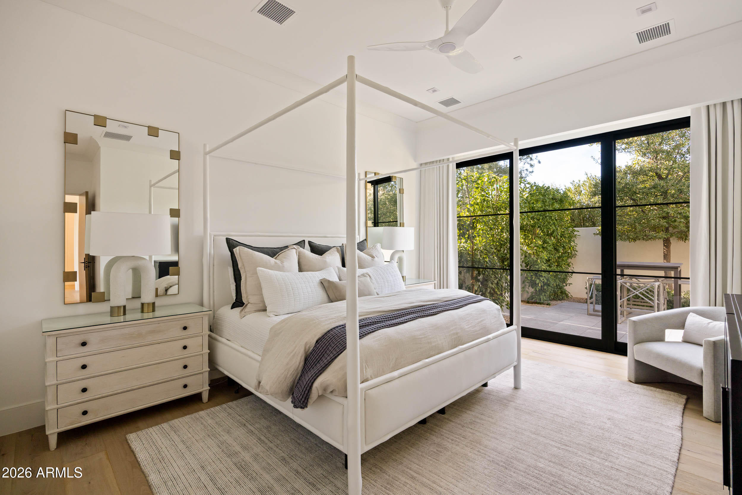 6800 North Mummy Mountain Road Paradise Valley, AZ 85253 - Photo 31 of 61 a large white bed sitting in a bedroom next to a window