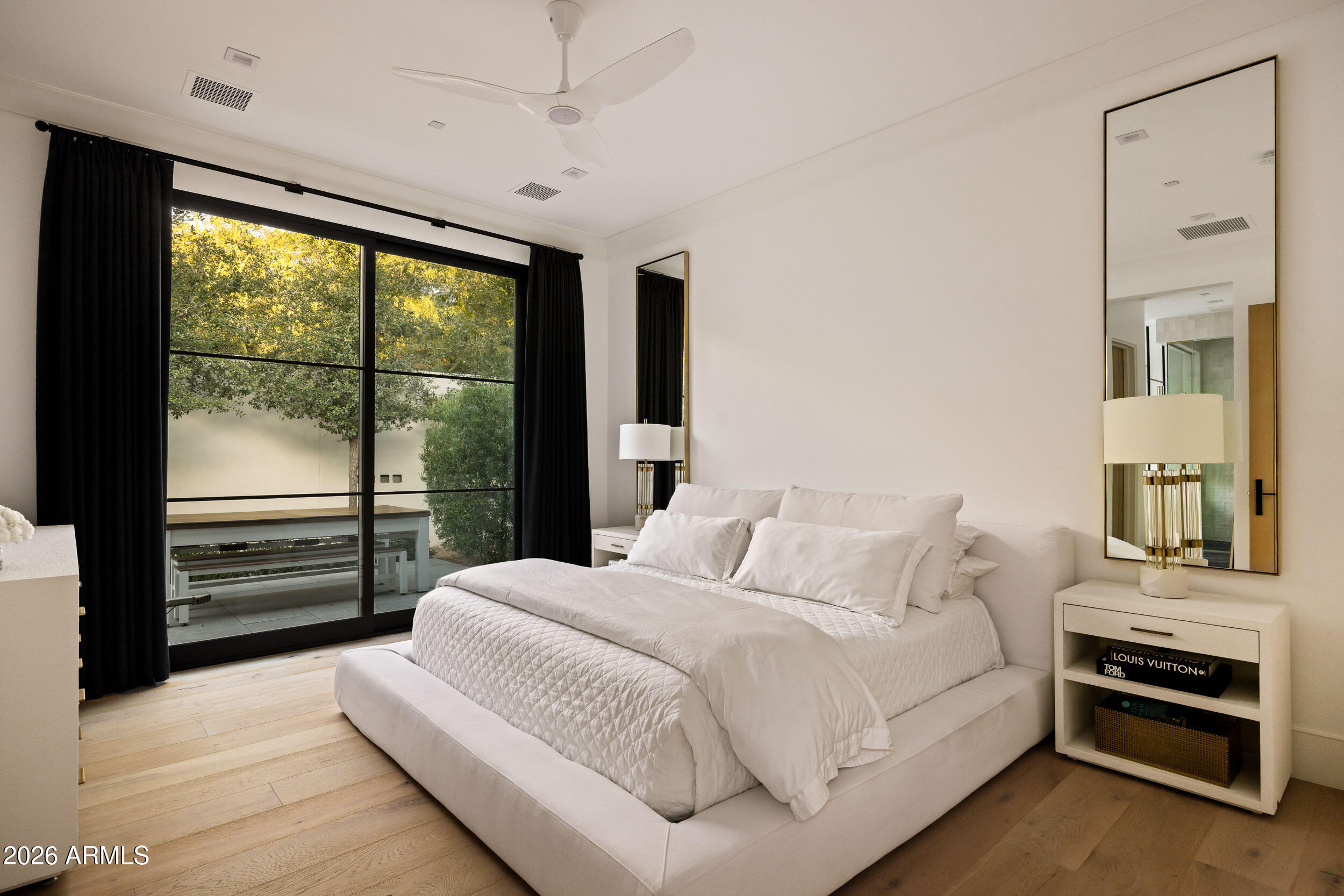 6800 North Mummy Mountain Road Paradise Valley, AZ 85253 - Photo 41 of 61 a bedroom with a bed and a large window