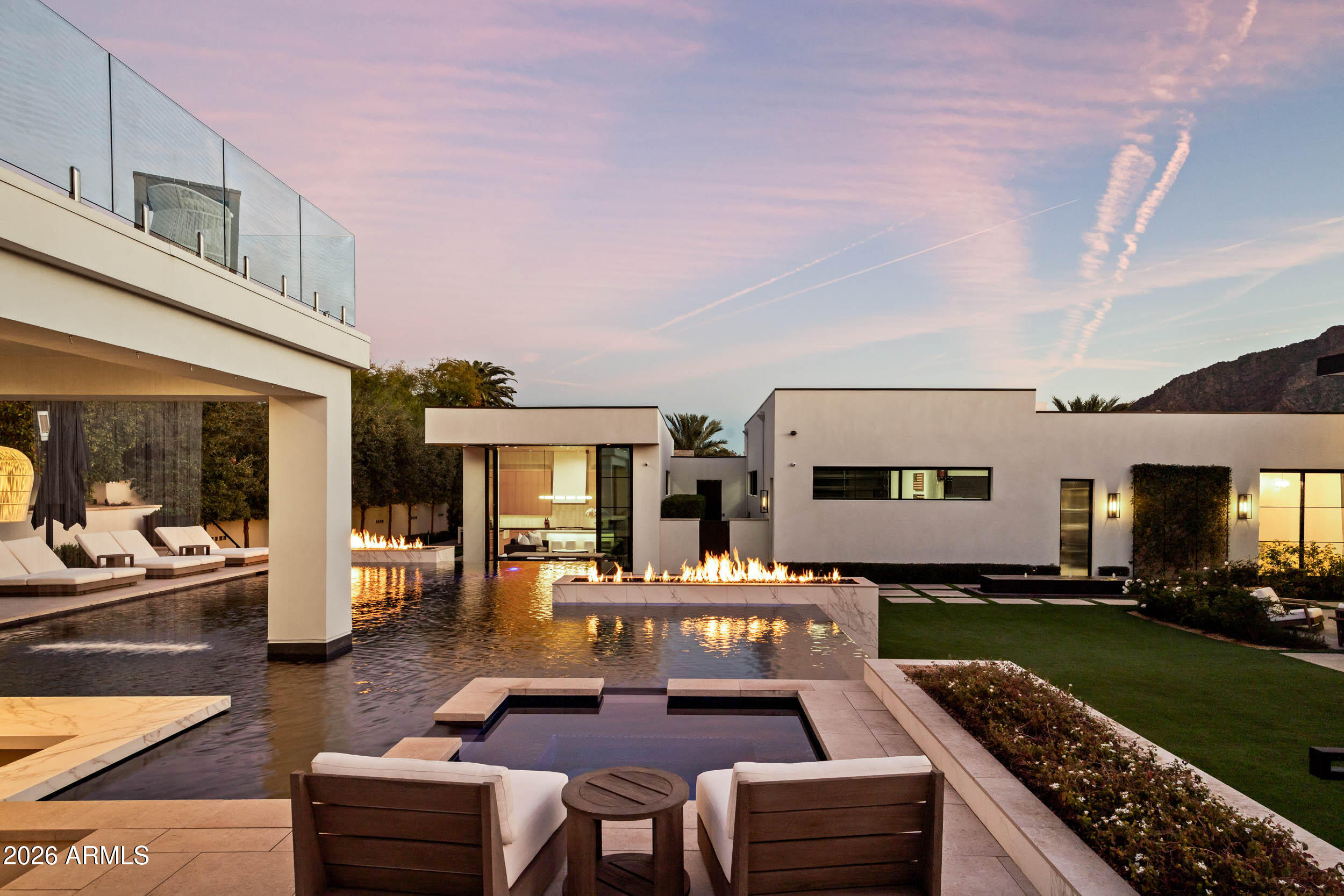 6800 North Mummy Mountain Road Paradise Valley, AZ 85253 - Photo 48 of 61 a living room with furniture a fireplace and a kitchen view