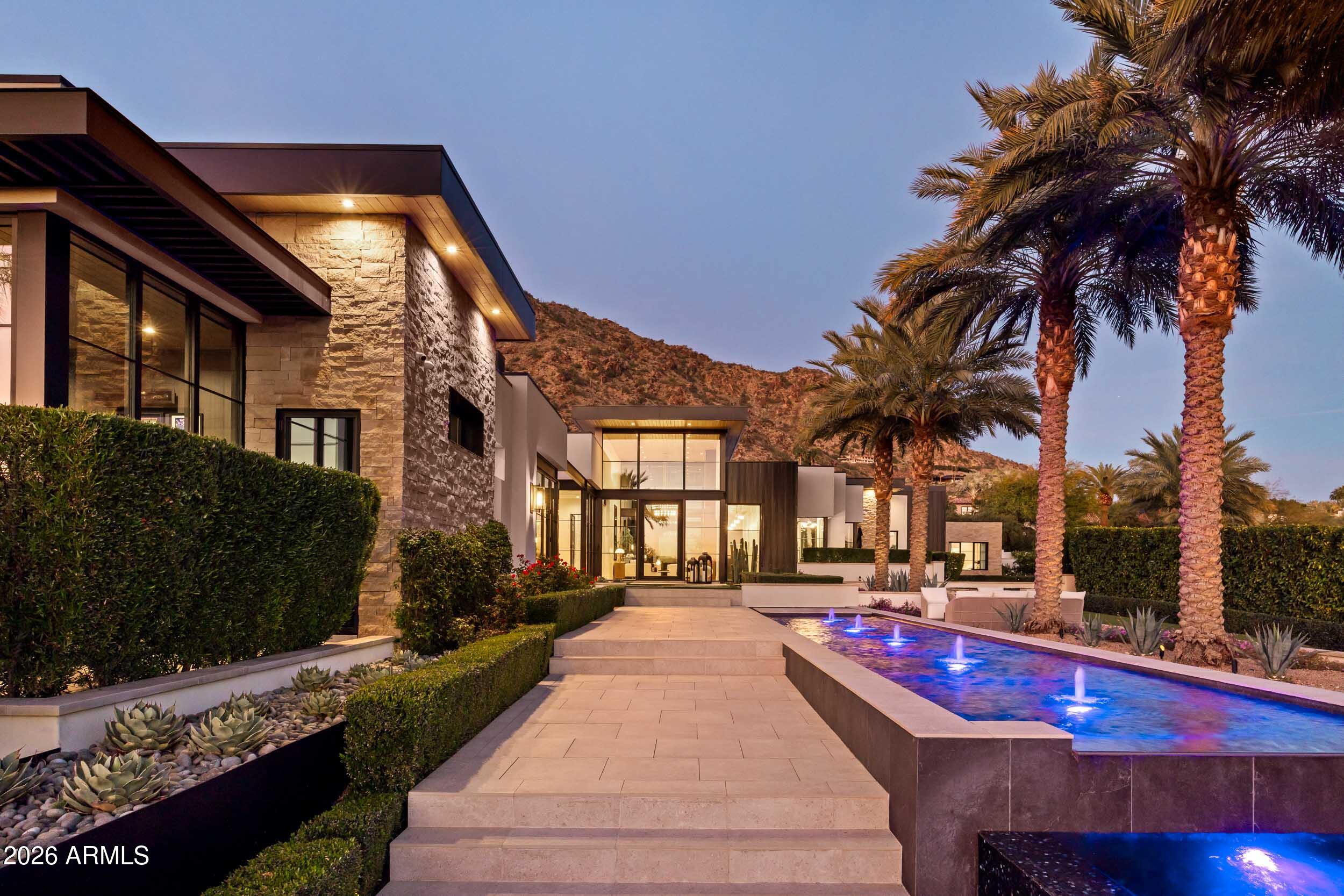 6800 North Mummy Mountain Road Paradise Valley, AZ 85253 - Photo 57 of 61 a view of a house with a swimming pool and a yard