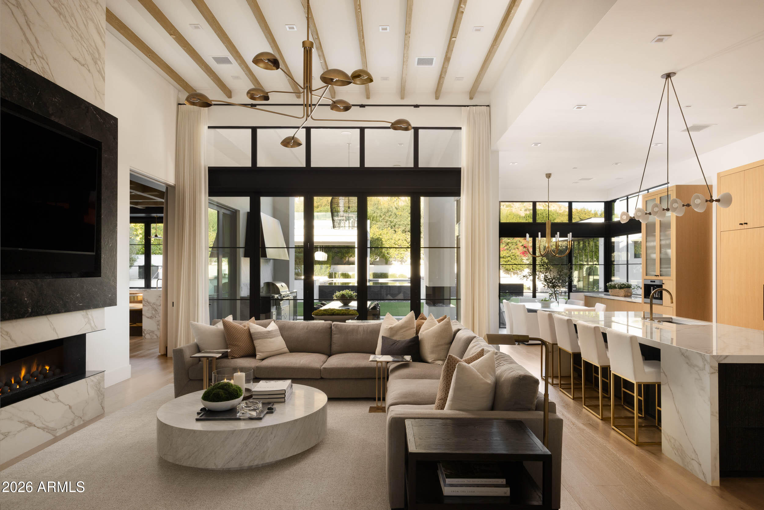 6800 North Mummy Mountain Road Paradise Valley, AZ 85253 - Photo 6 of 61 a living room with furniture a fireplace and a flat screen tv