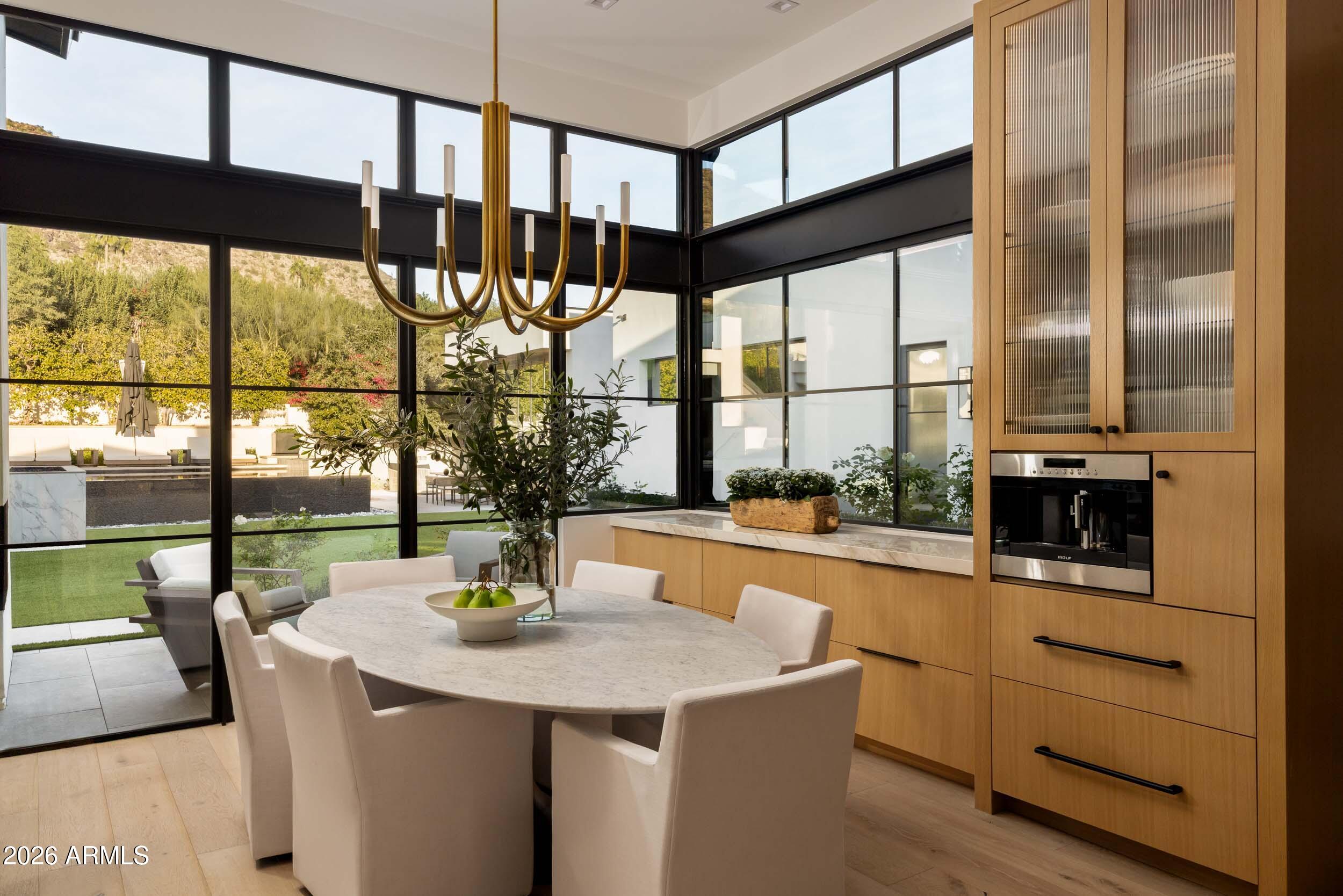 6800 North Mummy Mountain Road Paradise Valley, AZ 85253 - Photo 7 of 61 a kitchen with a sink a counter top space and living room view