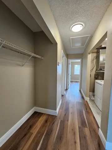a view of a room with wooden floor and staircase