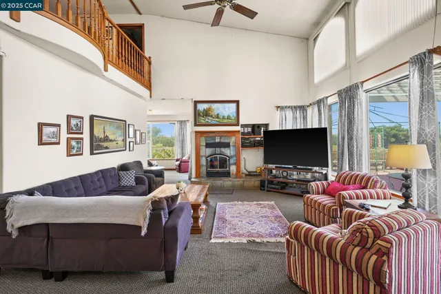 a living room with furniture fireplace and a table