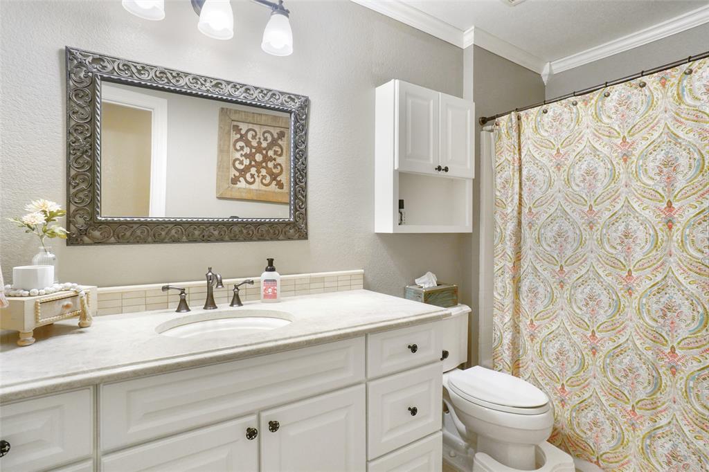 13340 John Day Road Haslet, TX 76052 - Photo 18 of 30 a bathroom with a granite countertop sink a toilet and a mirror