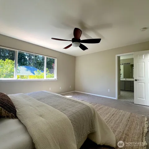a bedroom with a bed and a large window