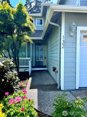 a view of a house with a flower garden