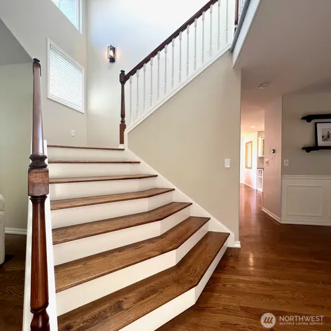 a view of entryway and hall with wooden floor