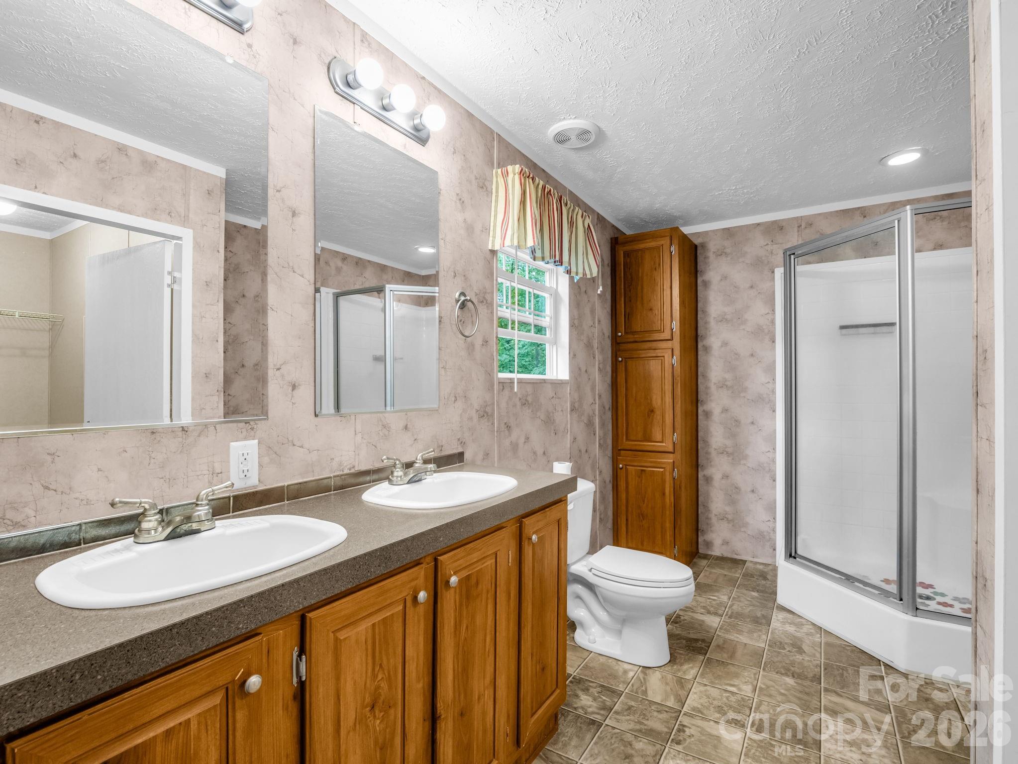 1449 Toney Road Bostic, NC 28018 - Photo 31 of 43 a bathroom with a double vanity sink toilet mirror and shower