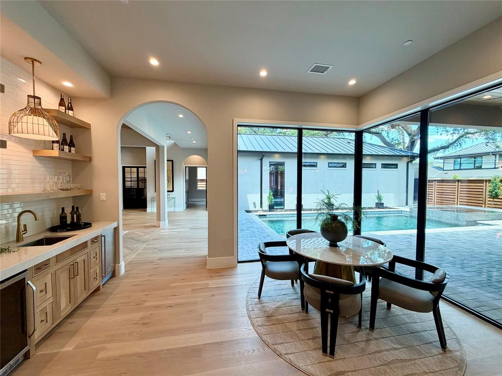11028 Edgemere Road Dallas, TX 75230 - Photo 14 of 40 Expansive glass walls overlook a paver patio and swimming pool