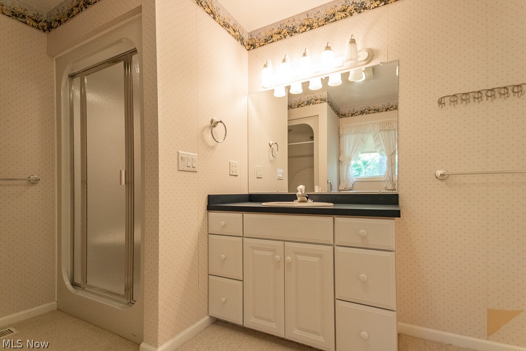 7710 Brakeman Road Painesville, OH 44077 - Photo 20 of 34 Bathroom with a shower with shower door and vanity