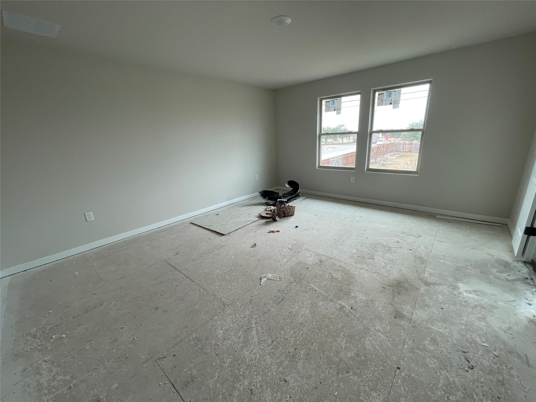601 Palo Brea Loop Hutto, TX 78634 - Photo 22 of 39 an empty room with windows and ceiling fan