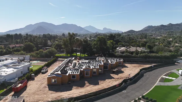 an aerial view of a house with pool and mountain view