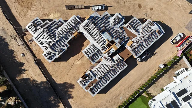 an aerial view of a house with large trees