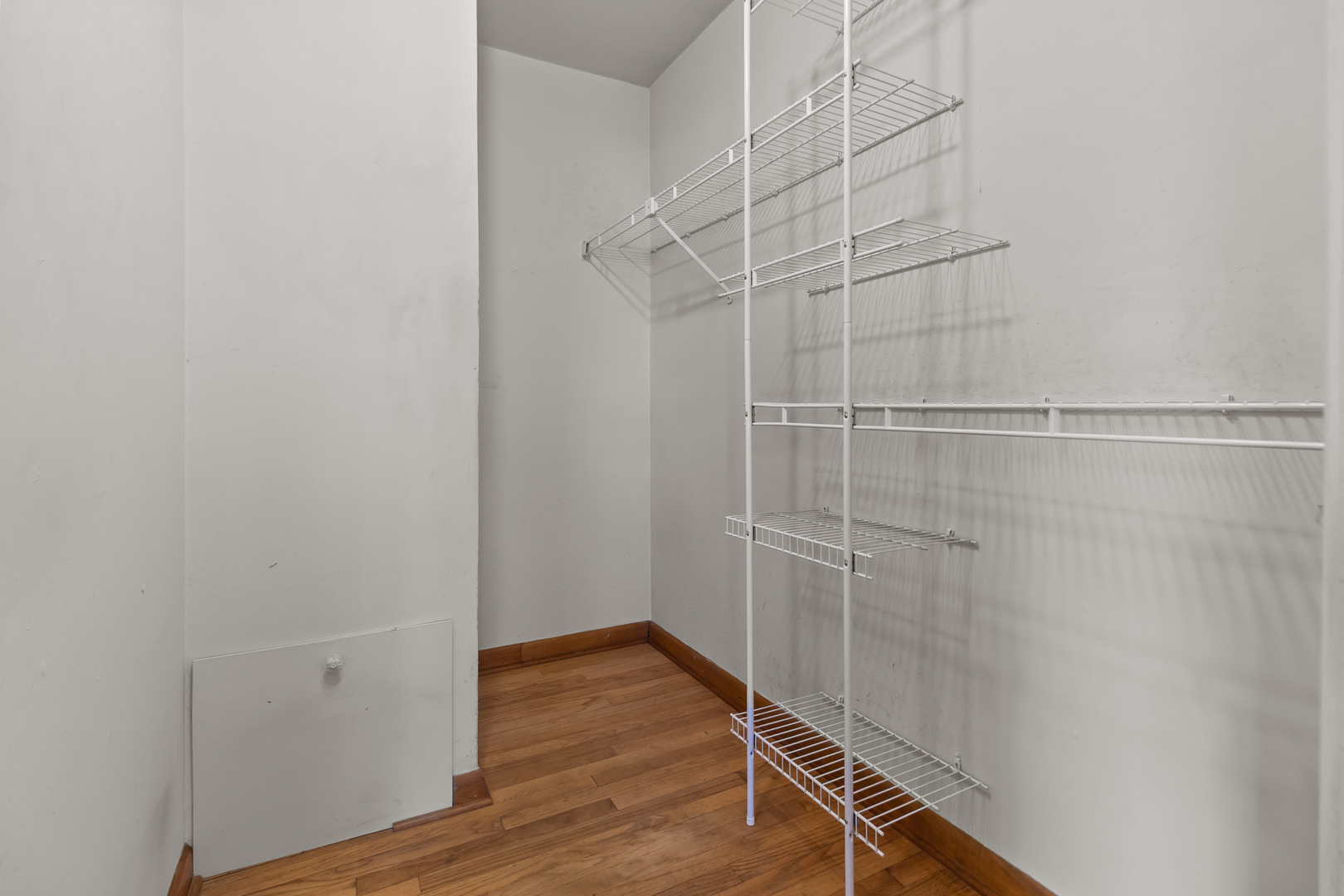 607 West Burbank Street Harvard, IL 60033 - Photo 11 of 22 a view of a room with wooden floor and white walls