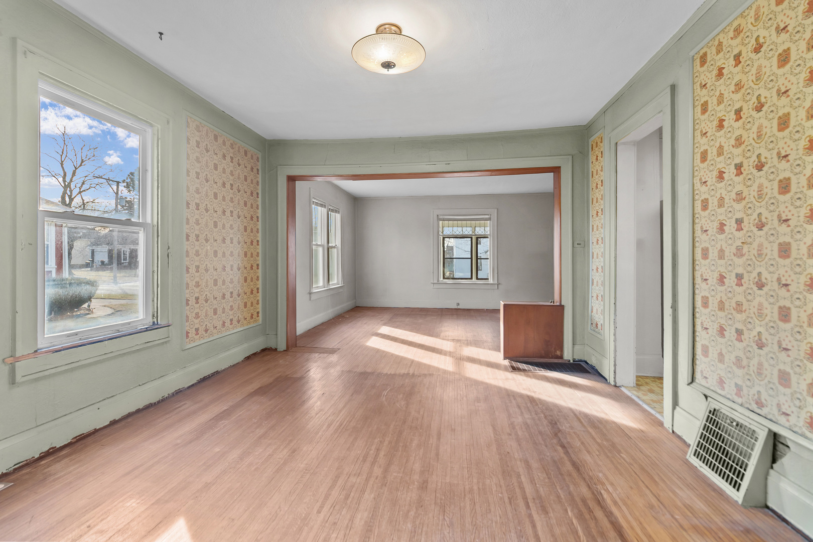 607 West Burbank Street Harvard, IL 60033 - Photo 14 of 22 an empty room with wooden floor and windows