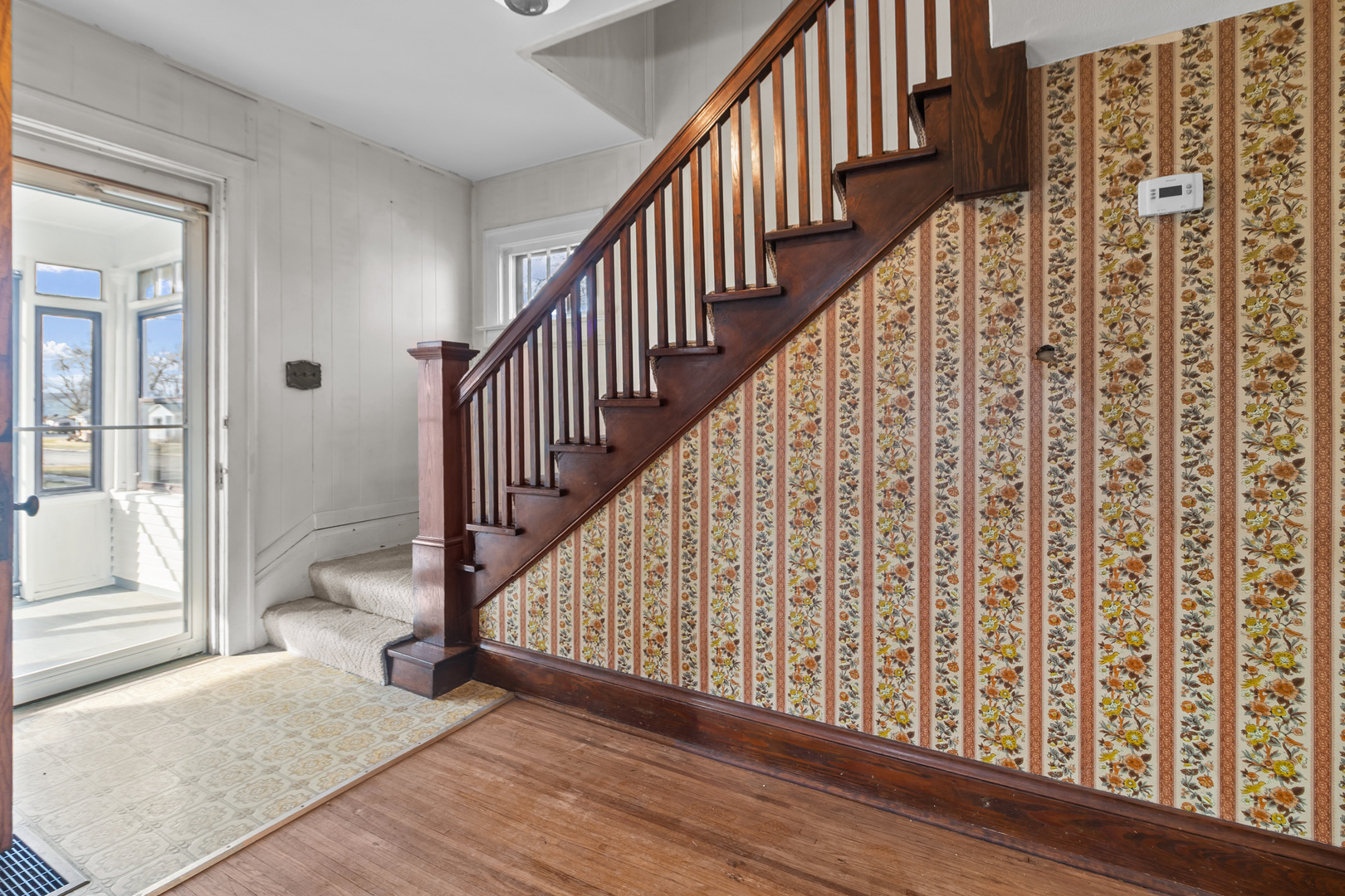 607 West Burbank Street Harvard, IL 60033 - Photo 4 of 22 a view of staircase with wooden floor and chair